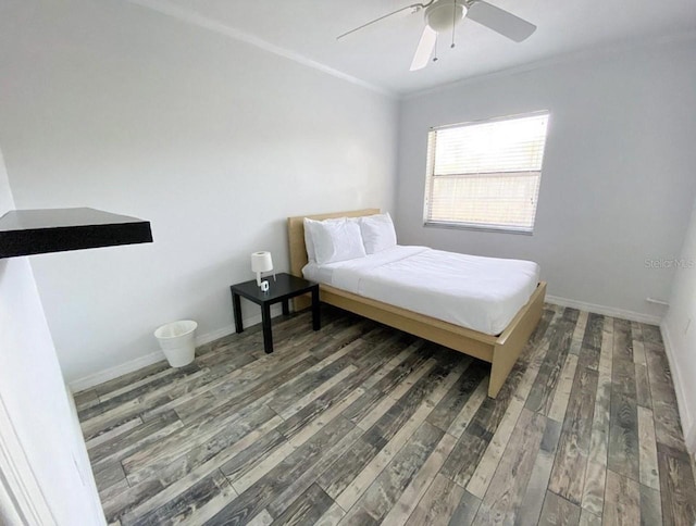 bedroom with dark wood-type flooring, ceiling fan, and ornamental molding