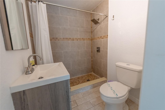 bathroom with tile patterned floors, vanity, walk in shower, and toilet