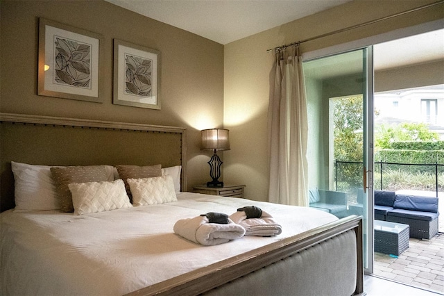 bedroom featuring access to exterior and light tile floors