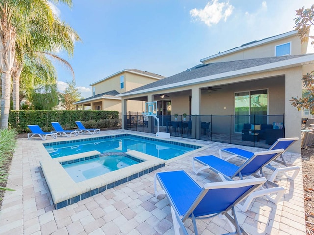 view of pool with a patio area and an in ground hot tub