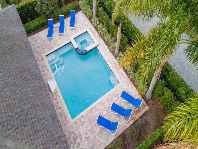 view of pool featuring an in ground hot tub and a patio