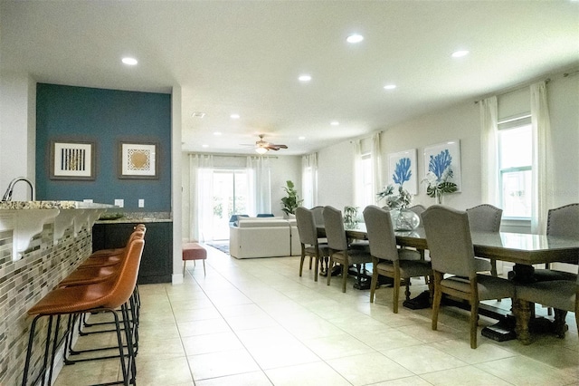 dining area with ceiling fan and light tile floors