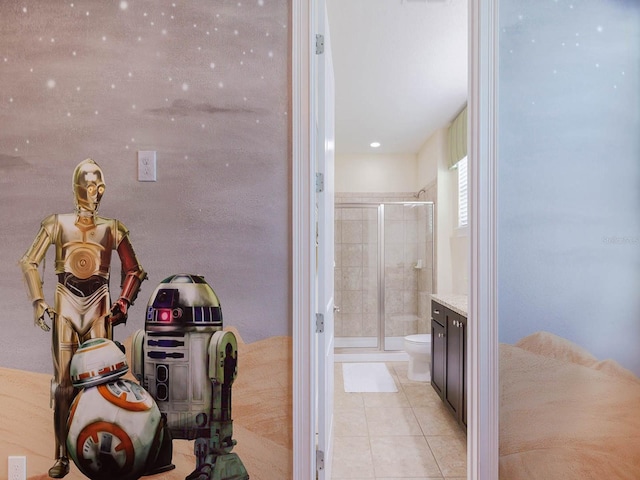 bathroom with an enclosed shower, vanity, tile flooring, and toilet