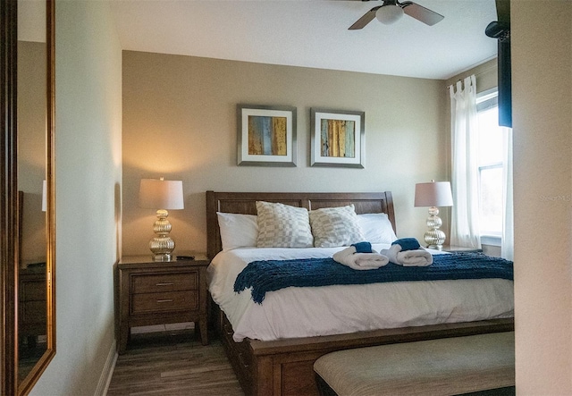 bedroom with ceiling fan and dark hardwood / wood-style flooring