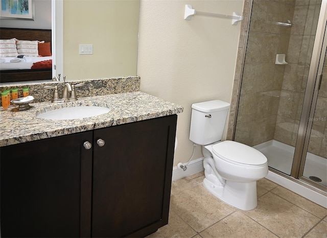 bathroom with tile floors, toilet, vanity, and a shower with door