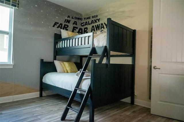 bedroom with wood-type flooring and multiple windows