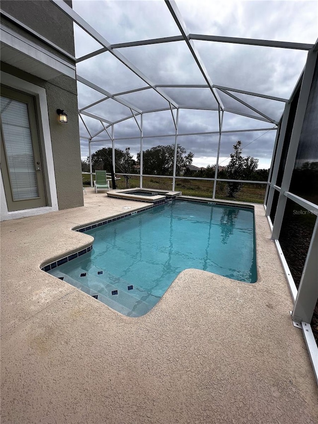 view of pool with a patio and a lanai