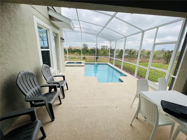 view of pool with a patio and a lanai