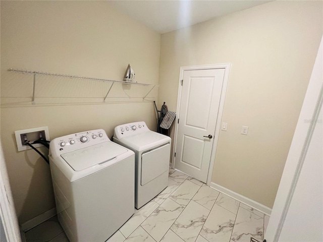 laundry area with washer hookup, independent washer and dryer, and light tile floors