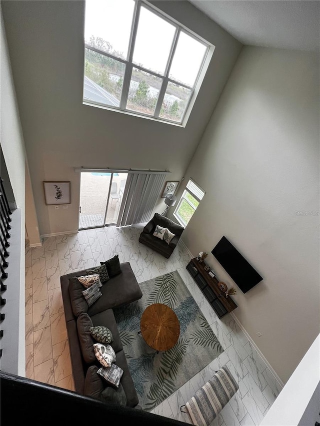 tiled living room featuring high vaulted ceiling