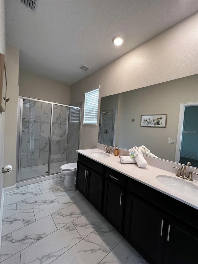 bathroom featuring an enclosed shower, tile flooring, a textured ceiling, toilet, and double vanity