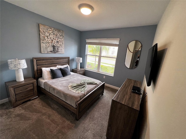 bedroom with dark colored carpet