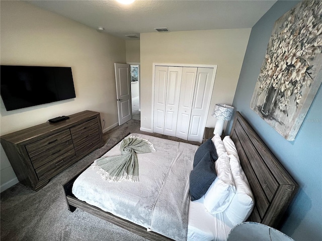 bedroom with a closet and dark carpet