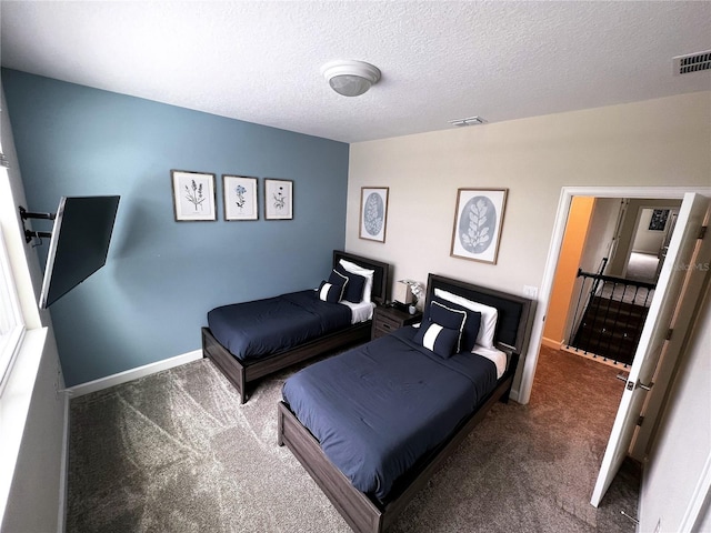 carpeted bedroom featuring a textured ceiling