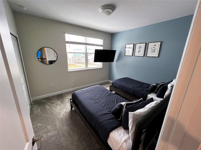 carpeted bedroom with a textured ceiling