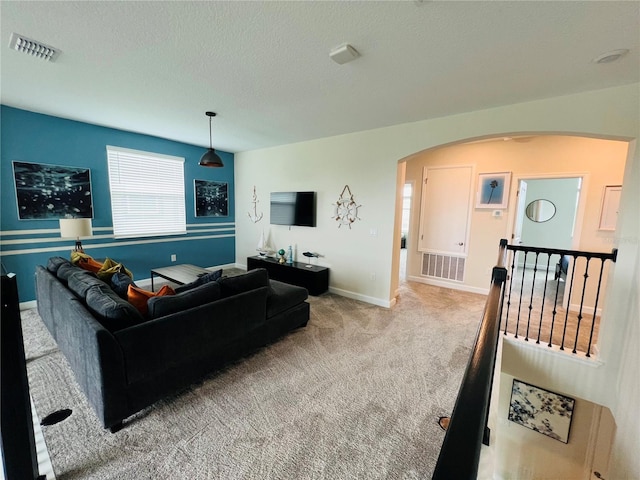 living room with light colored carpet and a textured ceiling