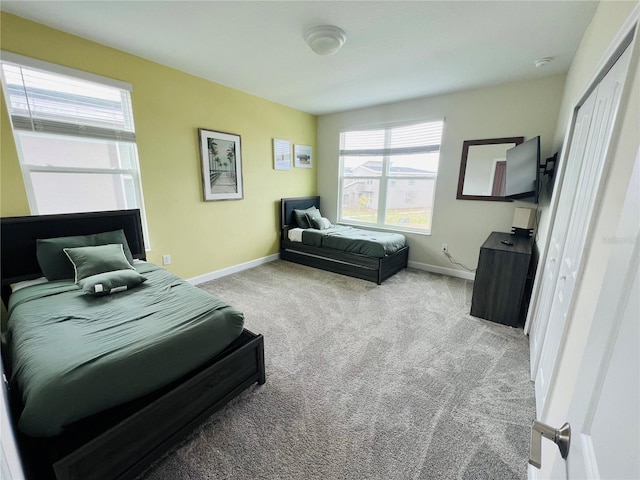 bedroom with a closet and light carpet