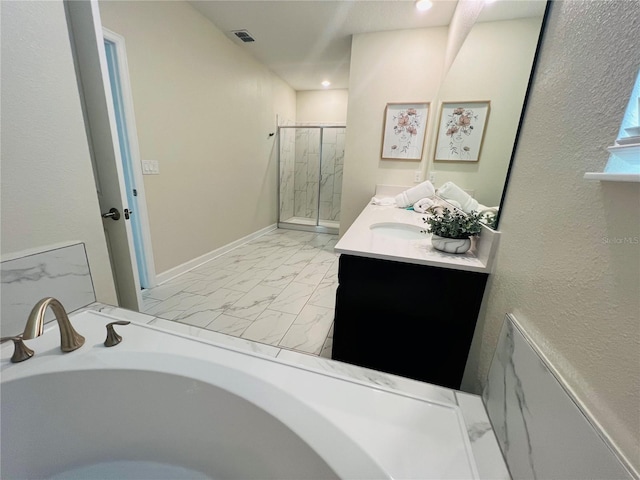 bathroom with vanity with extensive cabinet space and separate shower and tub