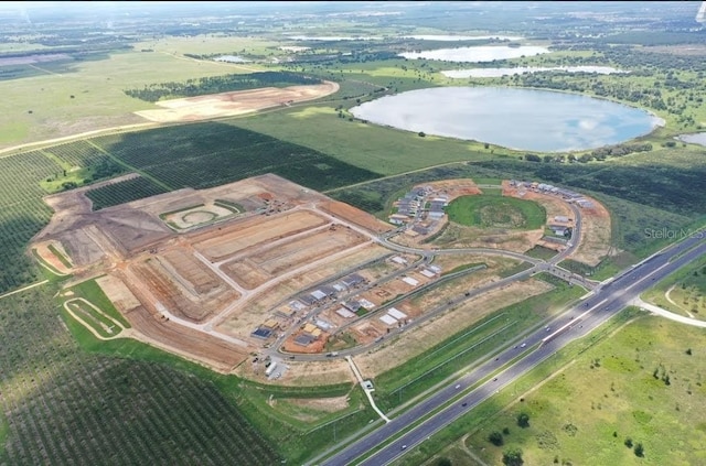 bird's eye view with a water view and a rural view