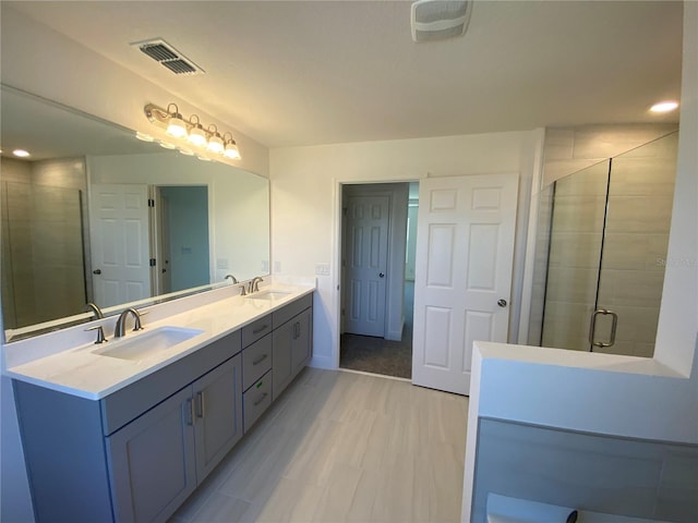 bathroom featuring vanity, wood-type flooring, and an enclosed shower