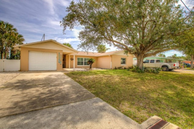 ranch-style home with a front lawn and a garage