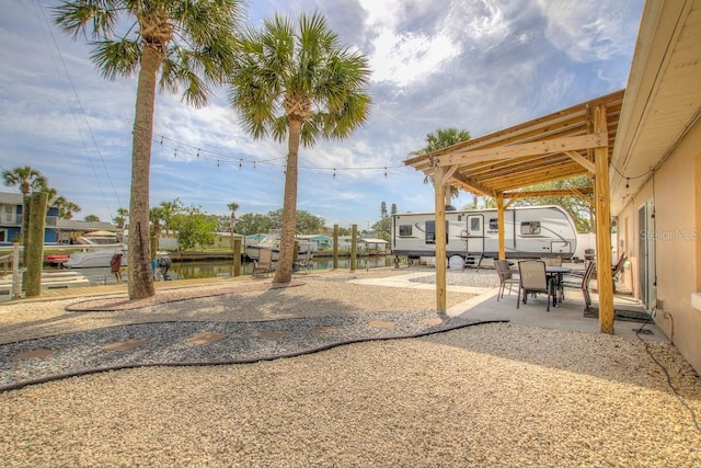 view of yard with a water view and a patio