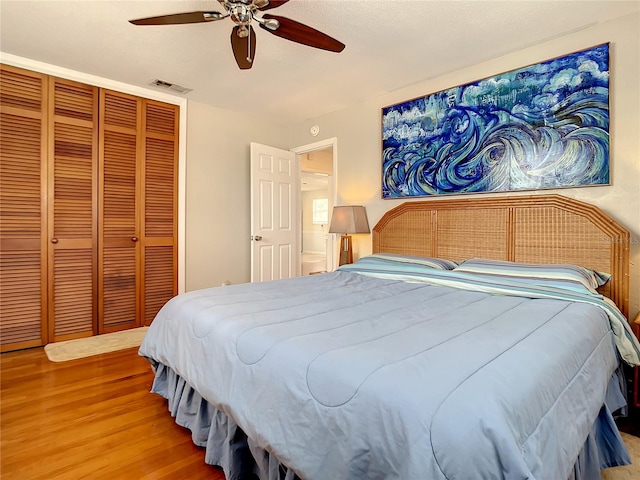 bedroom featuring light hardwood / wood-style flooring, a closet, and ceiling fan