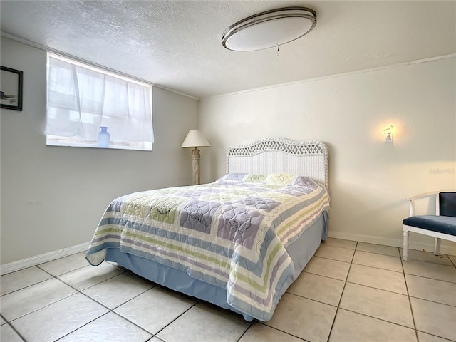 bedroom featuring light tile floors and a textured ceiling