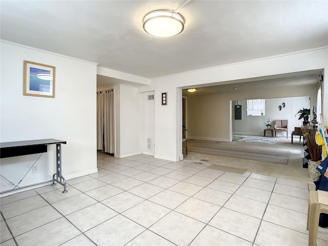 interior space with crown molding and light tile flooring