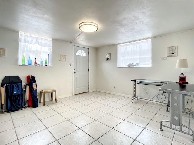 tiled foyer entrance with a healthy amount of sunlight