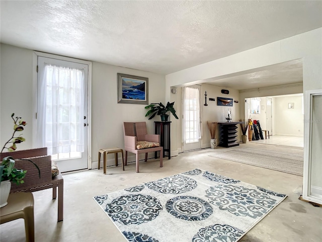 bedroom featuring a textured ceiling and multiple windows