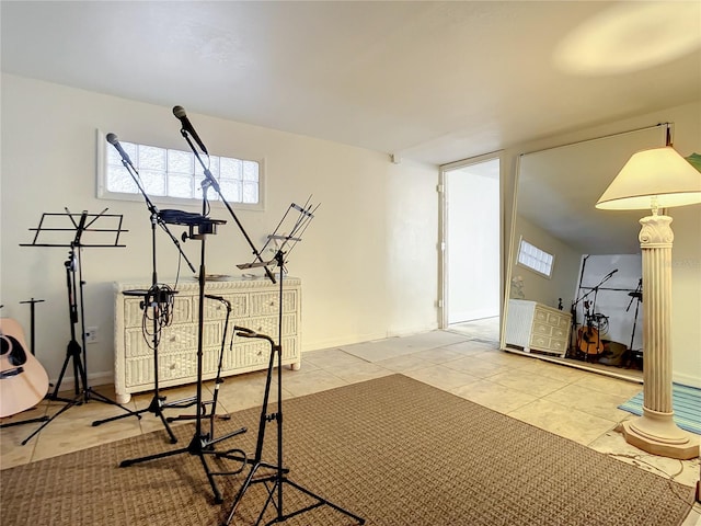 exercise room featuring light tile flooring