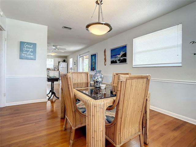 dining room with light hardwood / wood-style flooring and ceiling fan