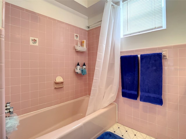 bathroom featuring shower / tub combo, tile floors, and tile walls