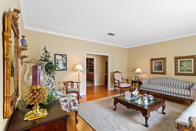 living room with ornamental molding and wood-type flooring