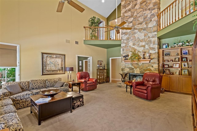 carpeted living room featuring high vaulted ceiling, ceiling fan, and a fireplace