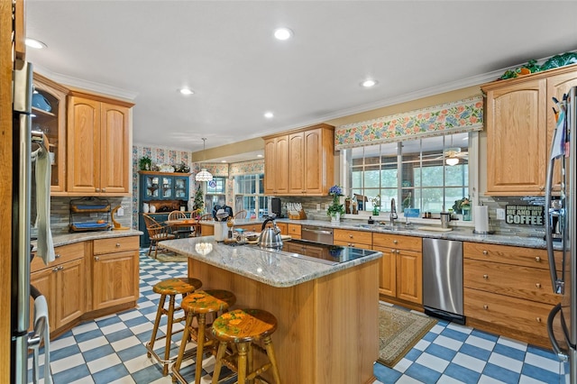 kitchen featuring backsplash, a center island, light tile flooring, and dishwasher