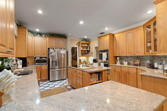 kitchen featuring stainless steel appliances, light tile floors, light stone countertops, backsplash, and sink