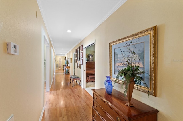 hall featuring light wood-type flooring and crown molding