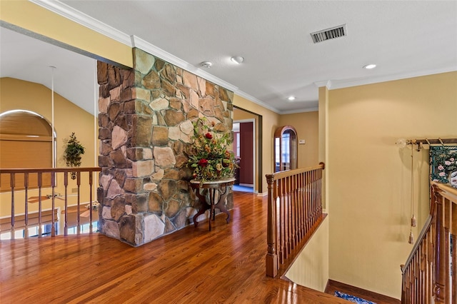 corridor with lofted ceiling, dark hardwood / wood-style flooring, and ornamental molding