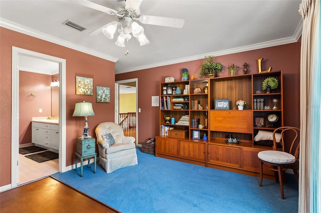 living area with ornamental molding, tile floors, ceiling fan, and sink