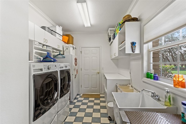 washroom with light tile floors, cabinets, washer and clothes dryer, crown molding, and sink