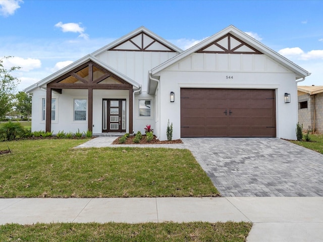 modern inspired farmhouse featuring a garage and a front yard