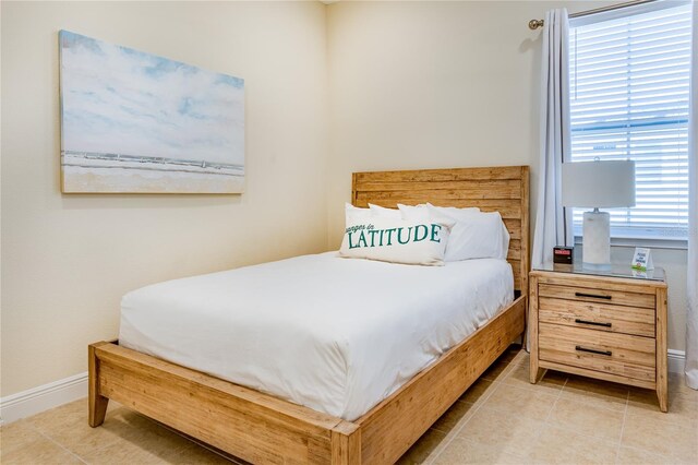 bedroom with light tile flooring