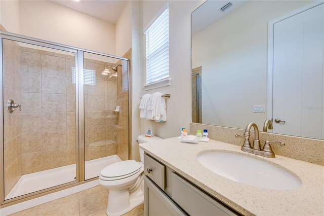 bathroom featuring tile floors, walk in shower, toilet, and vanity