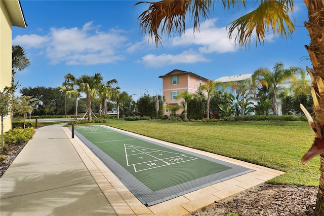 view of property's community with a lawn