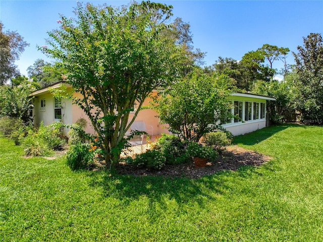 view of side of home featuring a lawn