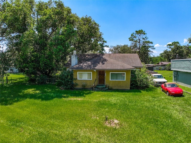 ranch-style home featuring a front yard