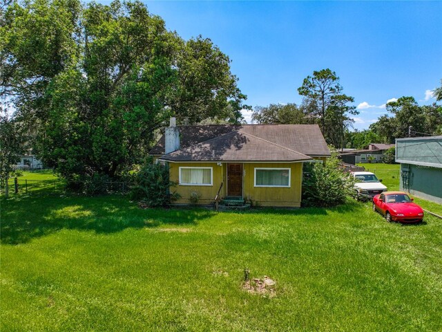 966 N Ronald Reagan Blvd, Longwood, FL 32750 - bungalow featuring a front lawn and a chimney