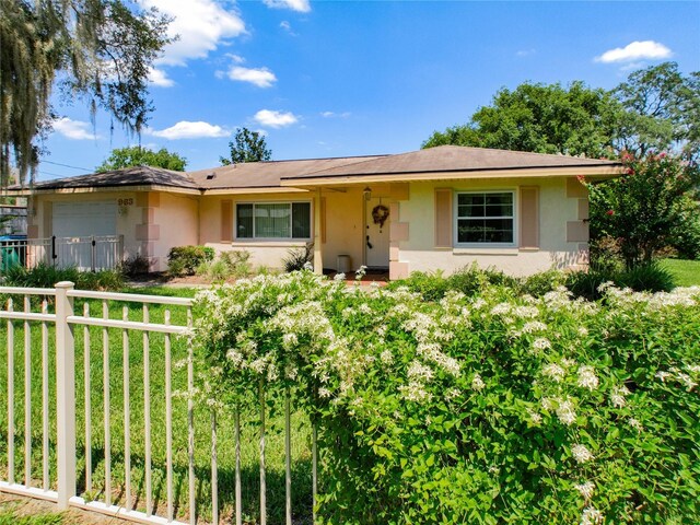 966 N Ronald Reagan Blvd, Longwood, FL 32750 - ranch-style house with a garage, stucco siding, and fence